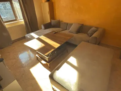 a living room with a couch and a table at Apartment 24 in Pamporovo