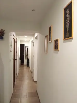 a hallway in a house with white walls and tile floors at Kamenitza Guest Flat in Plovdiv