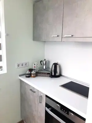 a kitchen with a white counter top with a stove at Kamenitza Guest Flat in Plovdiv