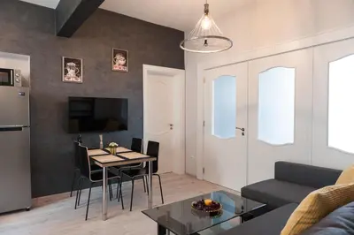 a living room with a couch and a table at Vitosha Blvd - 2BR LUX APART in Sofia