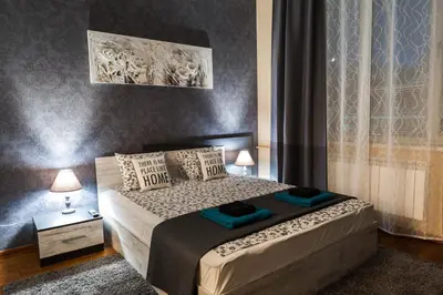 a bedroom with a bed with two pillows on it at Vitosha Blvd - 2BR LUX APART in Sofia