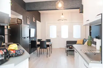 a kitchen and living room with a table and chairs at Vitosha Blvd - 2BR LUX APART in Sofia