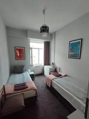 a bedroom with two beds and a window at Top Center Apartment 7 in Sofia