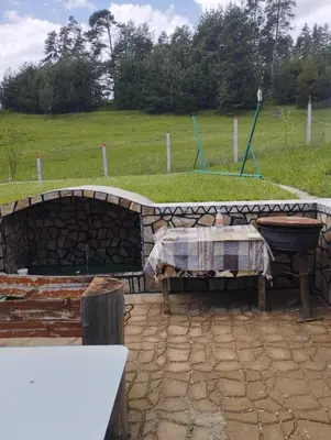 a patio with a table and a stone wall at Tolem in Borino
