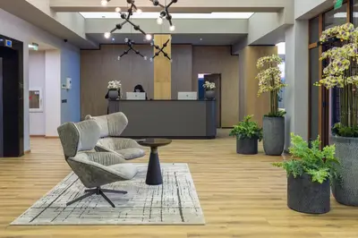 an office lobby with a chair and a table at Kamengrad Hotel & SPA in Panagyurishte
