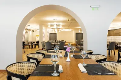 a dining room with a long table and chairs at Kamengrad Hotel & SPA in Panagyurishte