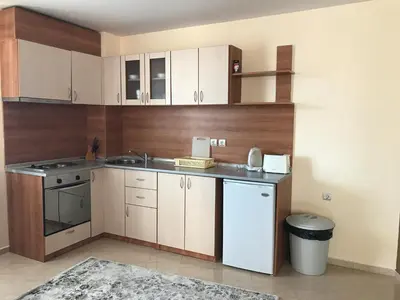 a kitchen with white cabinets and a sink at Apartment Lucy in Pamporovo