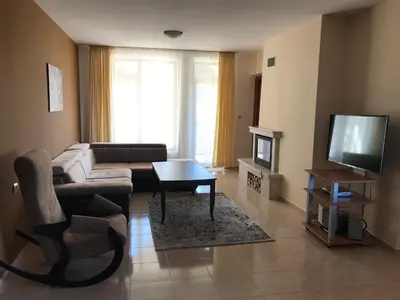 a living room with a couch and a tv at Apartment Lucy in Pamporovo