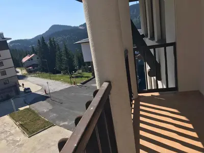 a balcony of a building with a view of a mountain at Apartment Lucy in Pamporovo