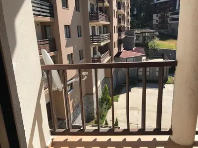 a balcony of a apartment building with a surfboard at Apartment Lucy in Pamporovo