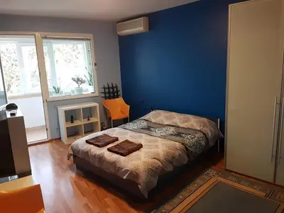a bedroom with a bed with a blue wall at blue room in Sofia