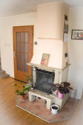 a fireplace in a living room with plants at Cosy, quiet house with Vitosha view near Paradise in Sofia
