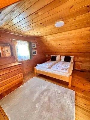a bedroom with a bed in a wooden cabin at Alpine ski chalet Borovets with sauna in Borovets