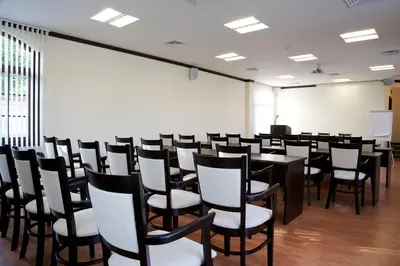 a conference room with a table and chairs at Hotel Domaine Peshtera in Peshtera