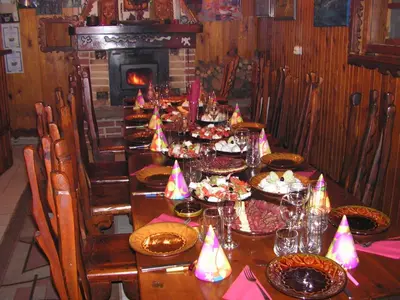 a long table with plates of food and a fireplace at Семеен хотел Калина Family hotel Kalina Говедарци in Govedartsi