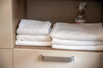 a stack of white towels sitting on top of a drawer at All Seasons Apartments Iglika 2 in Borovets