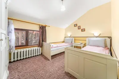 a bedroom with two beds and a window at House Shiligarnika in Bansko