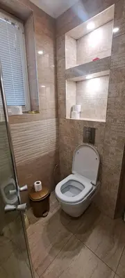 a bathroom with a toilet and a glass shower at Modern and Old Base in Sofia