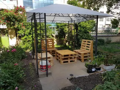 a picnic table and chairs under an umbrella at Modern and Old Base in Sofia
