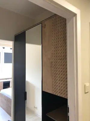 a closet with a glass door in a bedroom at Apartment 