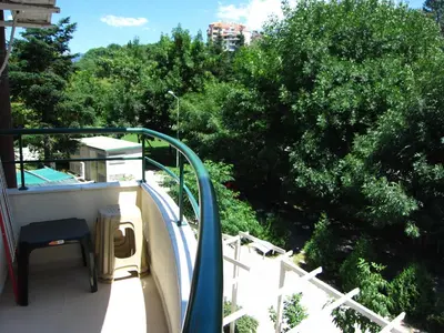a balcony with a table and chairs on a boat at Family Hotel Bistritsa in Sandanski