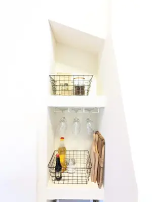 a wine cellar with wine glasses and a shelf at Casual Apartment near Gondola & City Center - Neon in Bansko