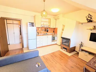 a kitchen with a blue couch and a refrigerator at Casual Apartment near Gondola & City Center - Neon in Bansko