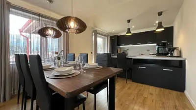 a kitchen with a wooden table and a dining room at Hyggemate - 2 Bed Room Warm Stay in Sarnitsa in Sarnitsa