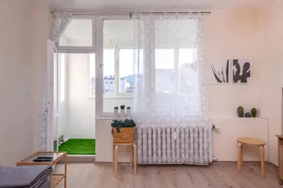 a living room with a window with a curtain at Atacama - spacious apartment in Lozenets area by Flat Mаnager by Flat Mаnager in Sofia