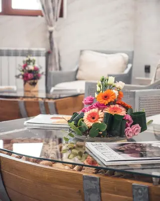a glass table with flowers on top of it at Villa Sintica in Sandanski
