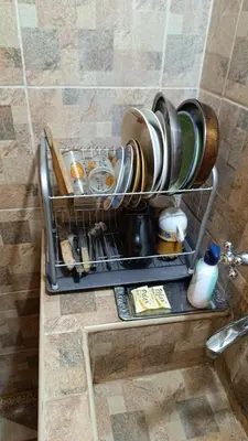 a rack with cups and other items on a bathroom counter at Guest Room Asparuh in Troyan