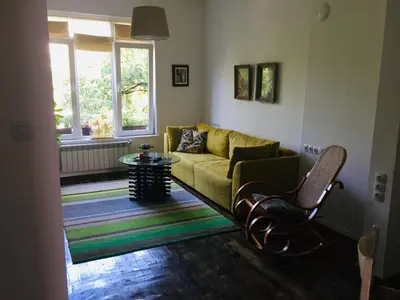 a living room with a couch and a table at Sweet home in the heart of Sofia in Sofia