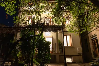 a building at night with trees in the foreground at The White House Sofia in Sofia