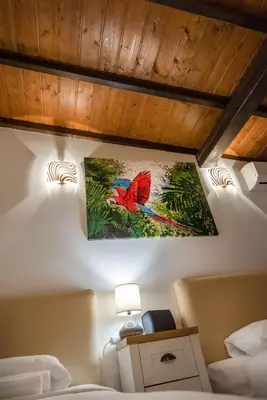 a painting of a bird on the wall of a bedroom at The White House Sofia in Sofia