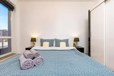 a bedroom with a large bed with towels on it at Apartment Valerie walking distance to Top Center in Plovdiv