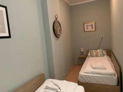 a small room with two beds and a mirror at Rivendell Apartments Flora Complex in Borovets