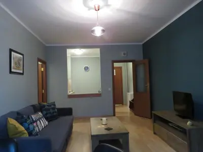 a living room with a couch and a tv at Rivendell Apartments Flora Complex in Borovets