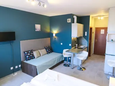 a small room with a bed and a table in it at Rivendell Apartments Flora Complex in Borovets