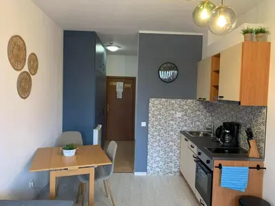 a kitchen with a table and a dining room at Rivendell Apartments Flora Complex in Borovets