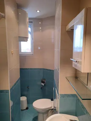 a bathroom with a toilet and a sink at Mladost 1 Apartment near the metro in Sofia