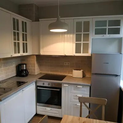 a kitchen with white cabinets and a stove top oven at Dolce Vita-Sofia Apartment in Sofia