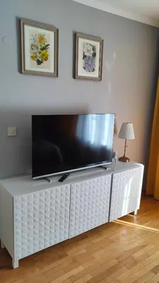 a large flat screen tv on a white entertainment center at Dolce Vita-Sofia Apartment in Sofia