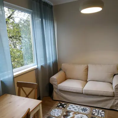 a living room with a couch and a window at Dolce Vita-Sofia Apartment in Sofia