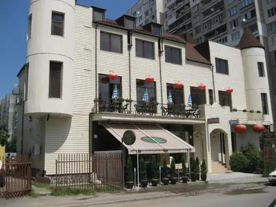a large white building with an awning in front of it at Family Hotel Marsina in Sofia