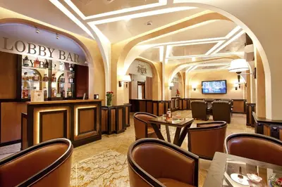 a restaurant with a bar and tables and chairs at Best Western Plus Bristol Hotel in Sofia