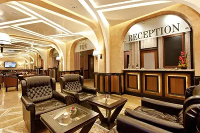 a hotel lobby with a reception desk and a television at Best Western Plus Bristol Hotel in Sofia