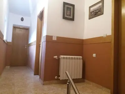 a room with a hallway with a radiator and a door at Comfort Guest House in Samokov