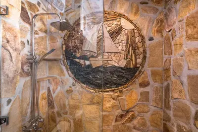 a wall with a mosaic of a sailboat in a mirror at ★ Chic & Elegant 1 Bedroom in Eagle's Nest Complex ★ Close to Gondola and Bar Street in Bansko