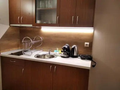 a kitchen counter with a sink and a microwave at private apartments Emerald in Bansko