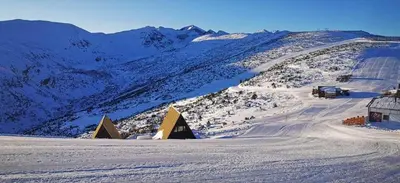 a snow covered mountain with a house and a road at Studio Villa Park 119 in Borovets